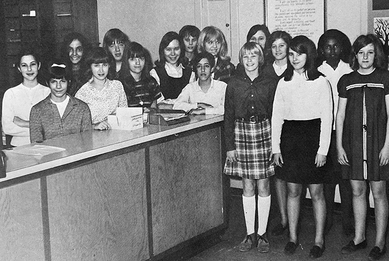 Black and white photograph showing a group of students in the school’s office.