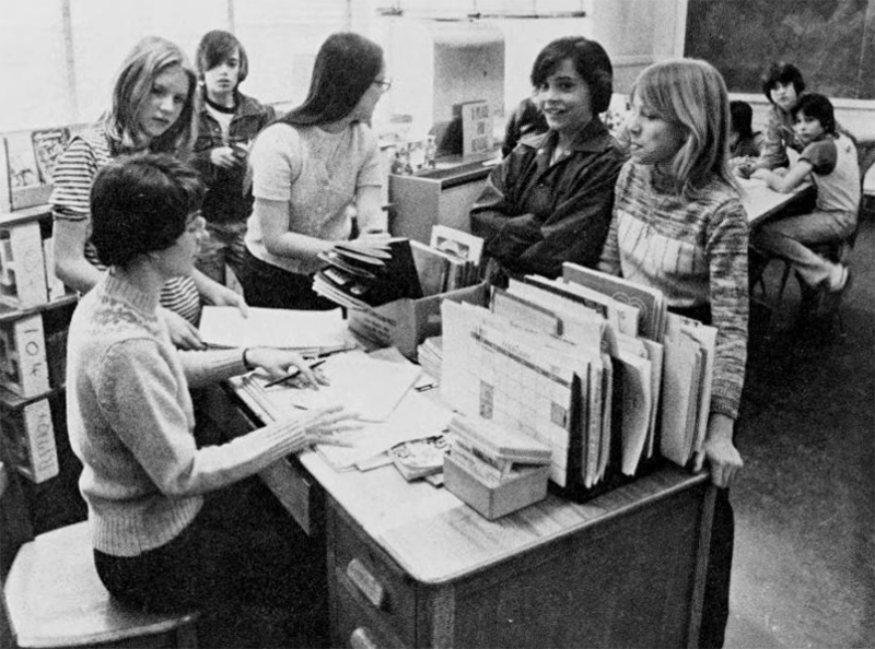 Black and white photograph showing students in a classroom.