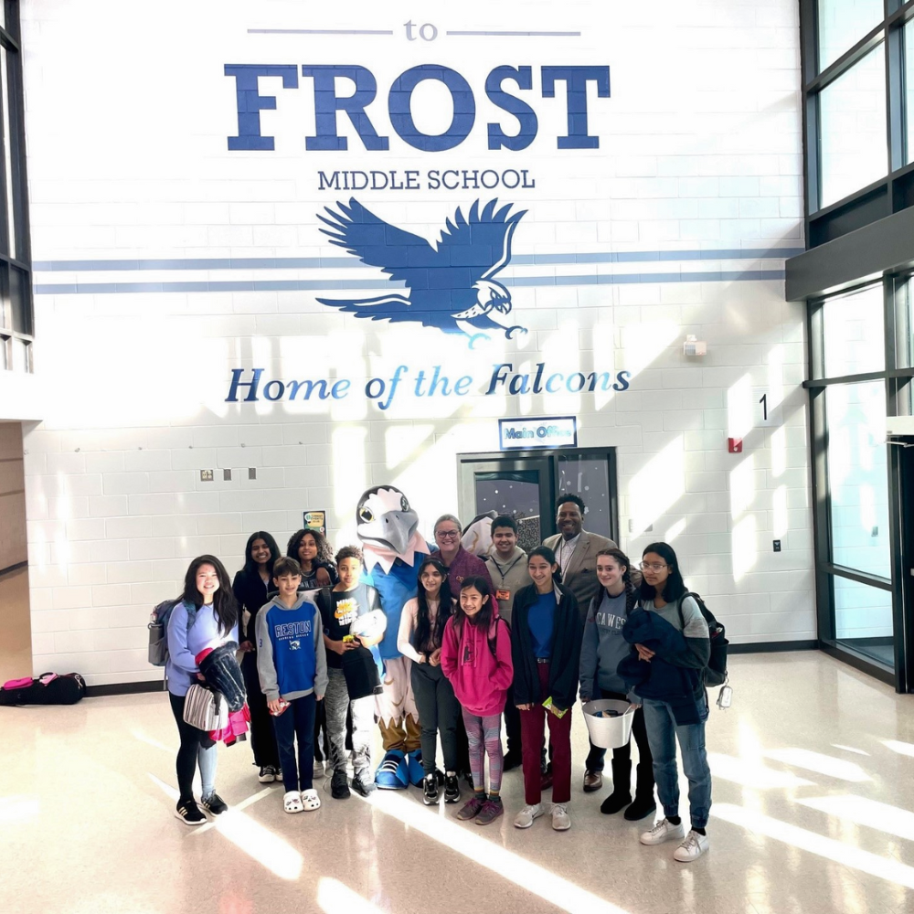 Dr. Reid with staff and students at Frost MS