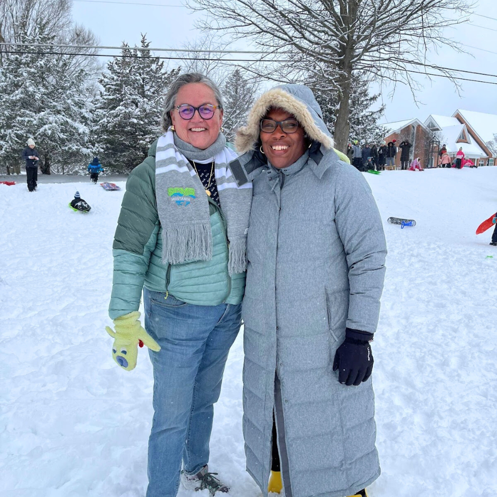 Dr. Reid enjoys the snow with Herndon ES Principal Candace Hunstad