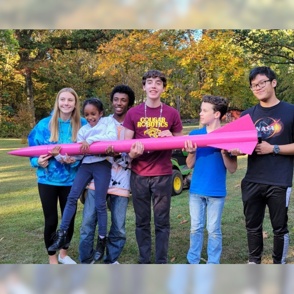 Oakton HS rocket club members pose with their rocket