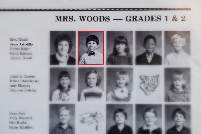 The new principal's photo appears in a page of a yearbook from when he was in first grade