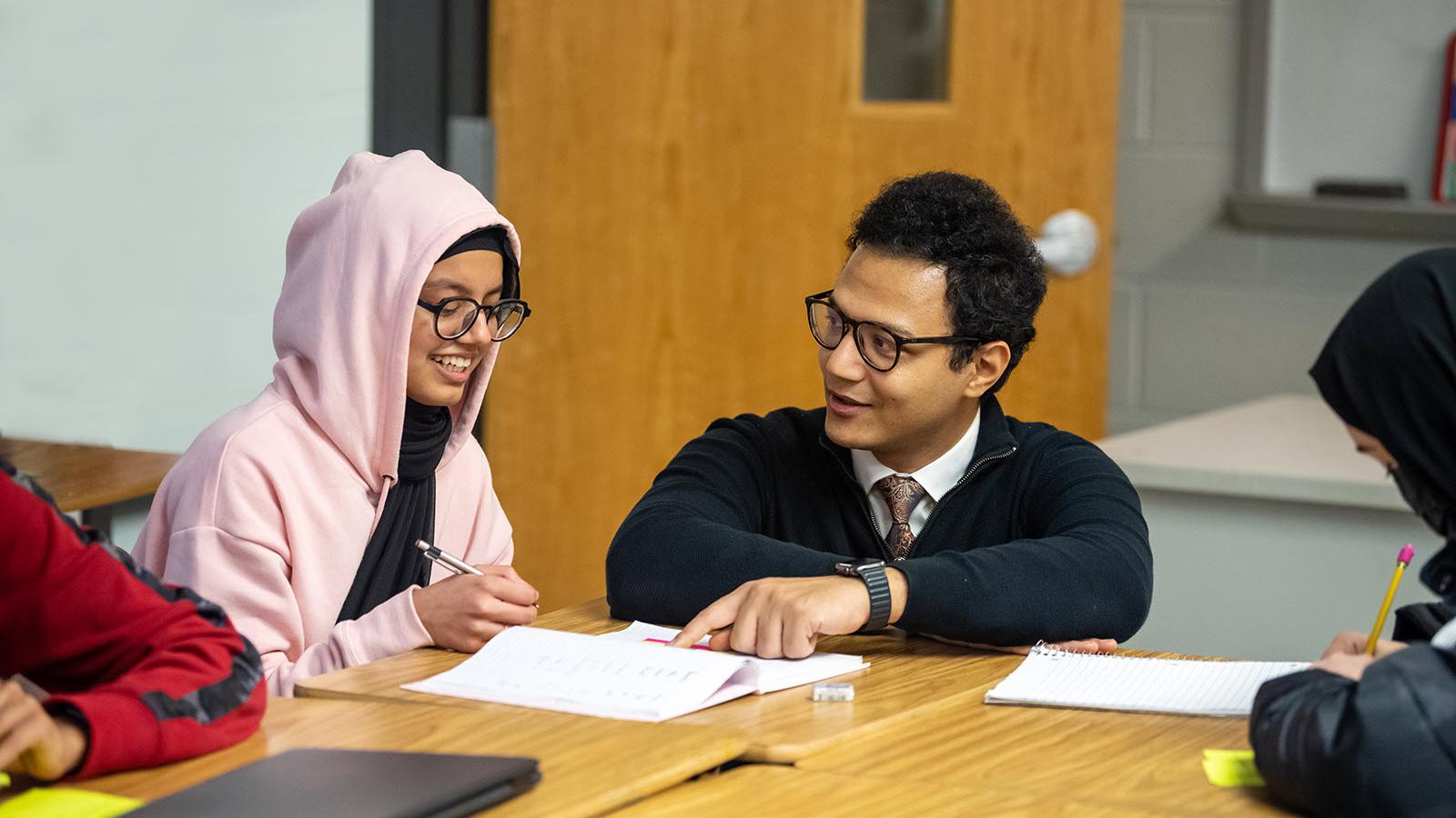 Arabic teacher working with student